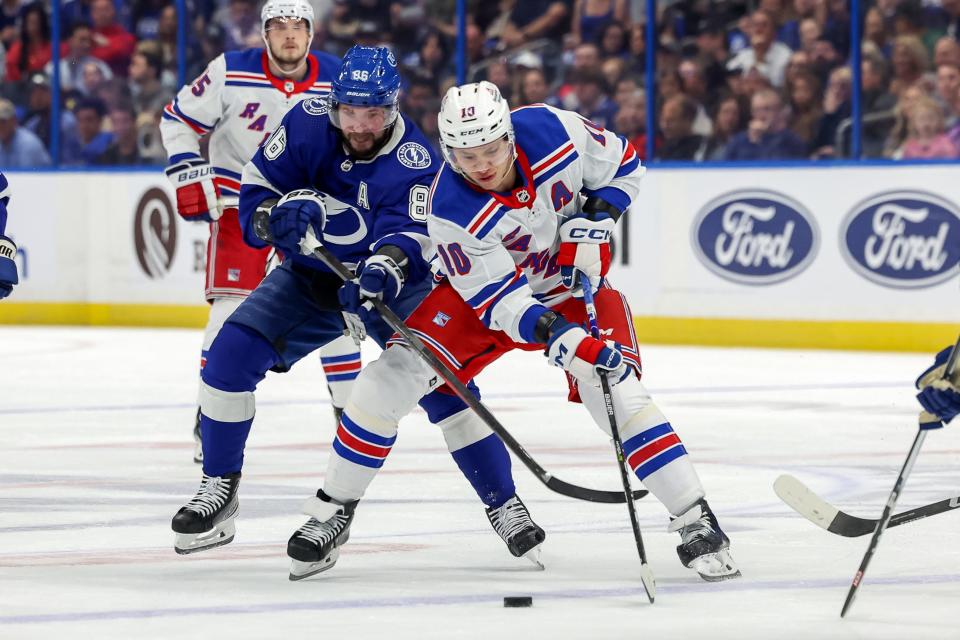 TAMPA, FL - MARCH 14: Artemi Panarin #10 of the New York Rangers avoids the check of Nikita Kucherov #86 of the Tampa Bay Lightning during the first period at the Amalie Arena on March 14, 2024 in Tampa, Florida.