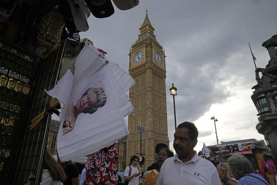 Flags printed with picture of Queen Elizabeth II are displayed for sale at a gift shop in London, Monday, Sept. 12, 2022. Just days after the death of Queen Elizabeth II, unofficial souvenirs have rolled out at royal-themed gift shops in London and online marketplaces like Amazon and Etsy. (AP Photo/Kin Cheung)