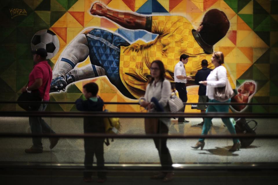 Passengers react to advertising panels depicting the World Cup in Brasilia International airport. (Ueslei Marcelino/Reuters)