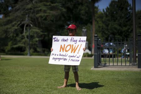 Eight year-old Ian Rutledge poses for a photograph before a rally outside the State House to get the Confederate flag removed from the grounds in Columbia, South Carolina June 23, 2015. REUTERS/Brian Snyder