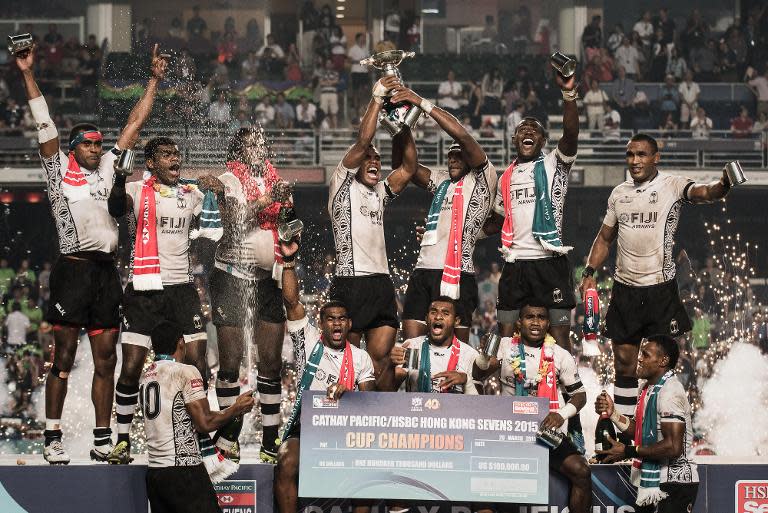 Fiji's players celebrate after defeating New Zealand in the final match of the rugby sevens tournament in Hong Kong on March 29, 2015