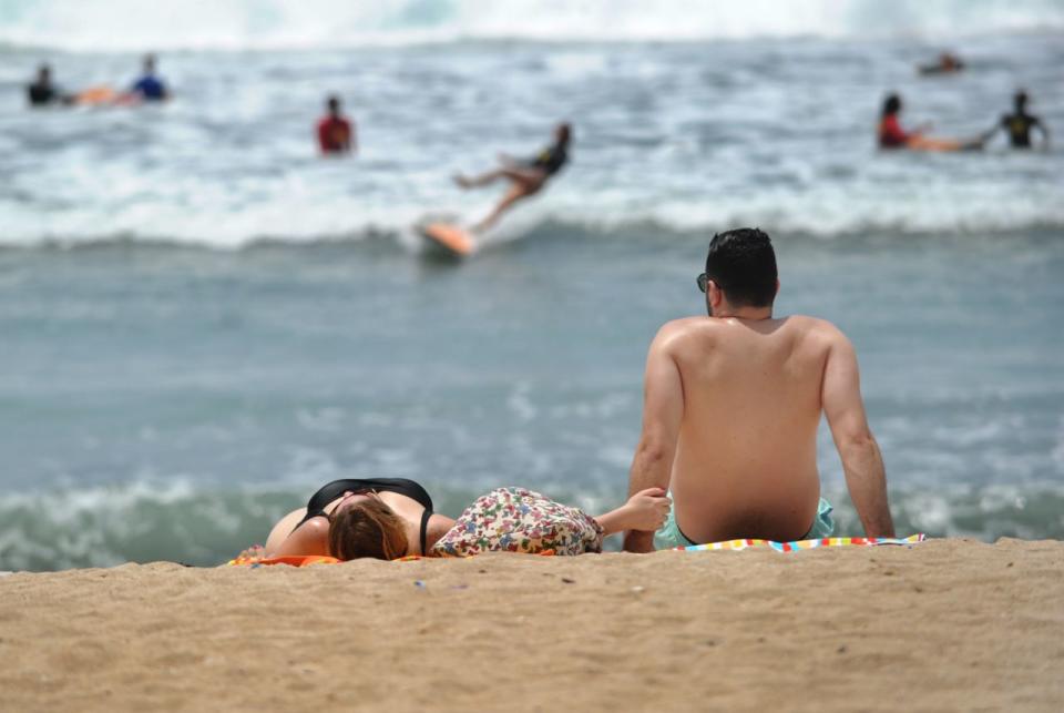 Bali, which is popular among tourists, is known for its beaches and some people argued the G-string bikini would offend the locals. Pictured is a stock image of people lying on the beach.