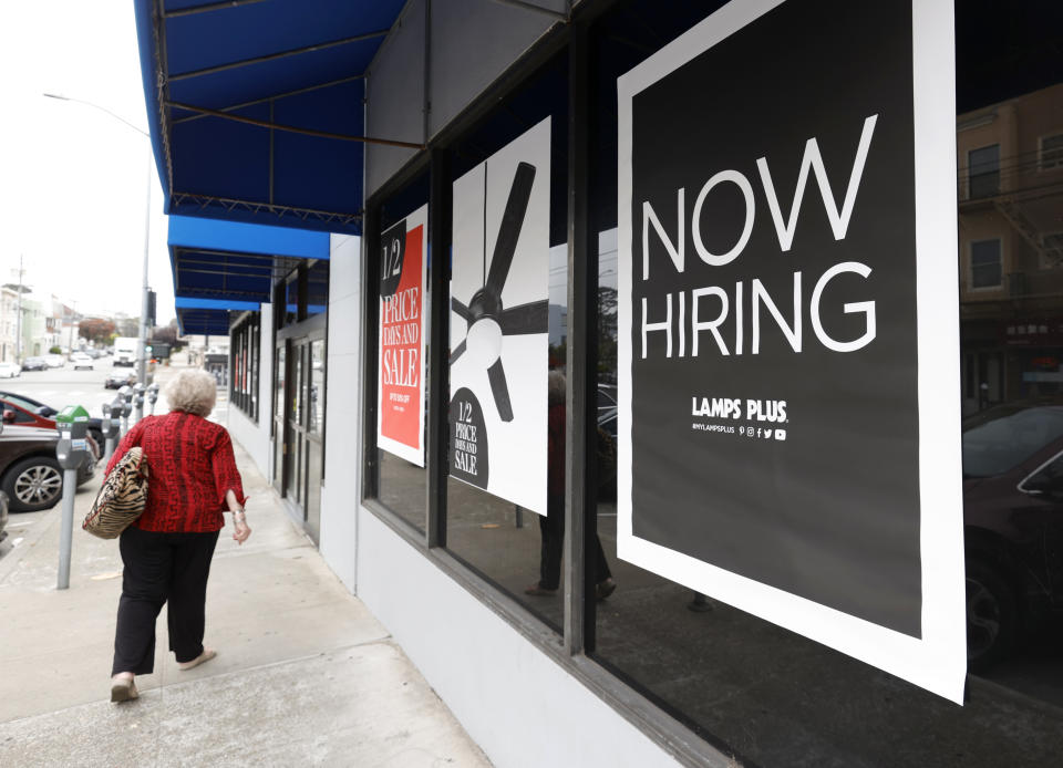 SAN FRANCISCO, CALIFORNIA - SEPTEMBER 16: A pedestrian walks by a now hiring sign at a Lamps Plus store on September 16, 2021 in San Francisco, California. Unemployment claims inched up to 332,000 from a pandemic low of 312,000 a week before. (Photo by Justin Sullivan/Getty Images)