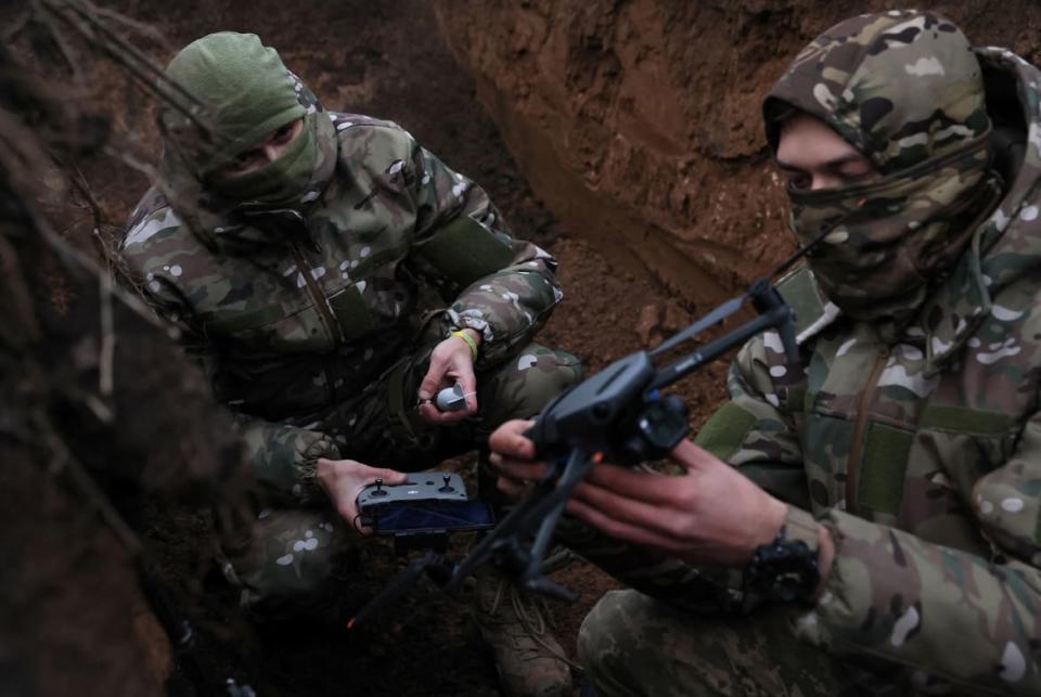 <div class="inline-image__caption"><p>Two soldiers with the 58th Independent Motorized Infantry Brigade of the Ukrainian Army who wanted to be identified as "Ghost," 24, and "Soap," 30, arm a drone with a modified grenade to test it, as Russia's invasion of Ukraine continues, near Bakhmut, Ukraine, November 25, 2022.</p></div> <div class="inline-image__credit">Leah Millis via Reuters</div>