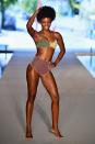 <p>A model wearing a color-block bikini walks the runway for the swimsuit show during the Paraiso Fashion Fair in Miami at the W South Beach hotel on July 15. (Photo: Alexander Tamargo/Getty Images for Sports Illustrated) </p>