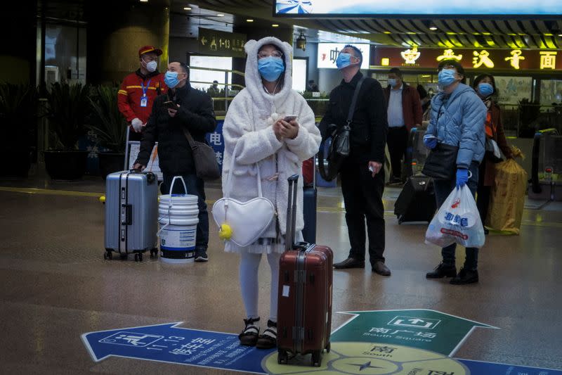 Travellers wear face masks at a train station following the outbreak of the coronavirus disease (COVID-19) in Beijing