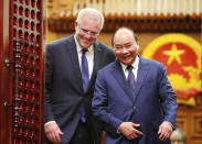 Australian Prime Minister Scott Morrison, left, and his Vietnamese counterpart Nguyen Xuan Phuc walk to a press briefing at the Government Office in Hanoi, Vietnam, Friday, Aug. 23, 2019. (AP Photo/Duc Thanh)