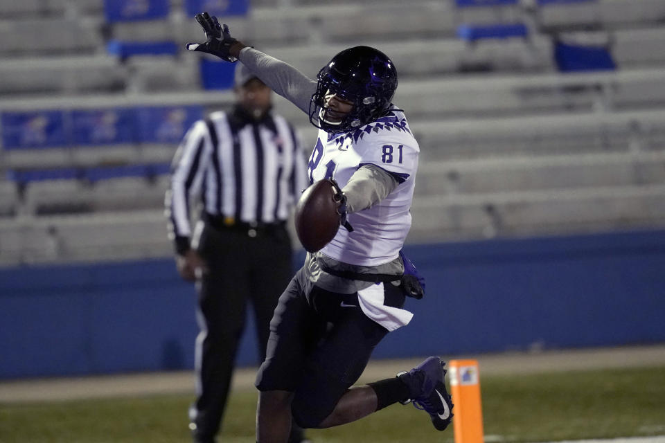 TCU tight end Pro Wells (81) celebrates after scoring a touchdown during the first half of an NCAA college football game against Kansas in Lawrence, Kan., Saturday, Nov. 28, 2020. (AP Photo/Orlin Wagner)