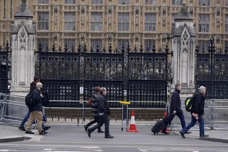 Pedestrians walk past Carriage Gate at the Houses of Parliament, which is the scene of a recent attack, in London, Britain March 24, 2017. REUTERS/Darren Staples