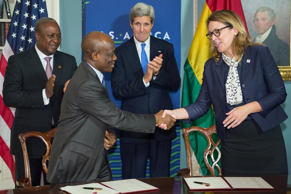 Ghana President John Dramani Mahama(Rear L), and US Secretary of State John Kerry(Rear R) applaud as Ghana Finance Minister Seth Terkper(Front L) and Dana Hyde, CEO of the Millennium Challenge Corporation (MCC), shake hands after signing the Ghana Compact during ceremonies at the State Department August 6, 2014 in Washington, DC. The US governments Millennium Challenge Corporation (MCC) releases the second MCC compact of $498 million for investment in the transformation of Ghanas electricity sector and the stimulation of private investment in the area. Over 50 African leaders are in Washington attending the three-day US-Africa Summit. AFP PHOTO/Paul J. Richards (Photo credit should read PAUL J. RICHARDS/AFP via Getty Images)