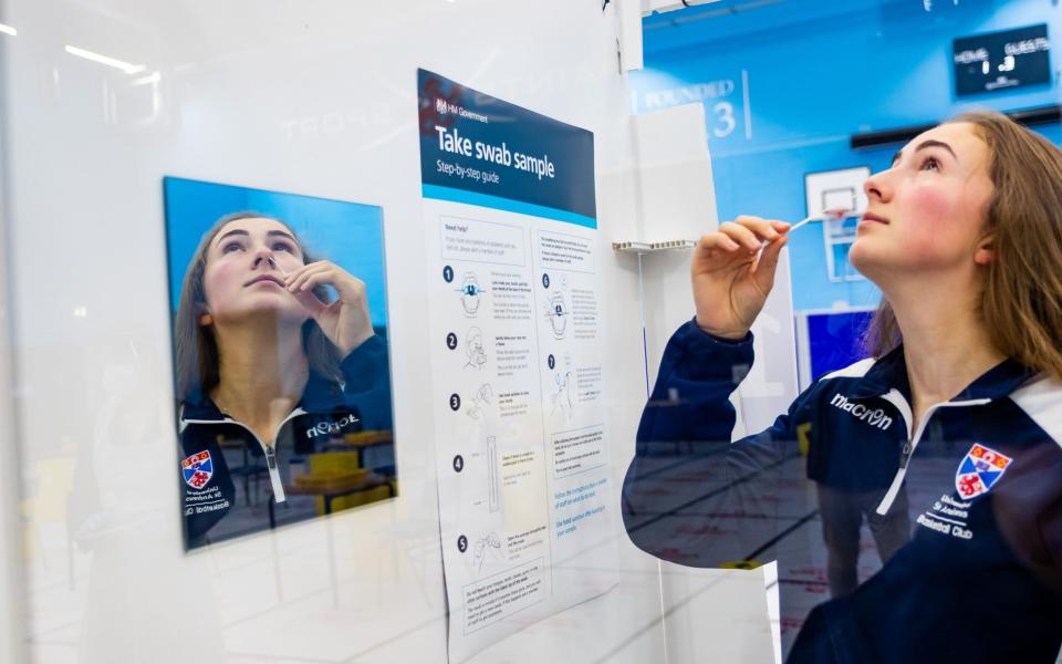 Student at St Andrews University testing themselves for coronavirus as part of the mass testing scheme - Stuart Nicol