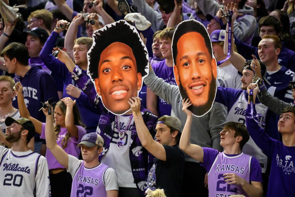 Members of the Kansas State student section hold up photos of Nae'Qwan Tomlin and Markquis Nowell during last Tuesday's game against Oklahoma State at Bramlage Coliseum. The Wildcats will have another sellout crowd this Tuesday when they face Kansas in the Sunflower Showdown.