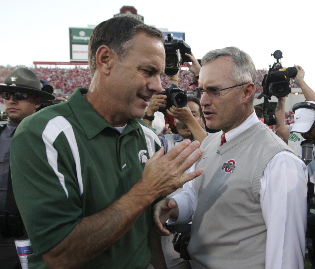 Michigan State coach Mark Dantonio, left, meets Ohio State coach Jim Tressel at midfield after Ohio State's 24-17 win, Oct. 20, 2007, in Columbus.