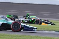 Romain Grosjean, of Switzerland, drives through the grass at the start of the IndyCar Grand Prix auto race at Indianapolis Motor Speedway, Saturday, May 11, 2024, in Indianapolis. (AP Photo/Darron Cummings)