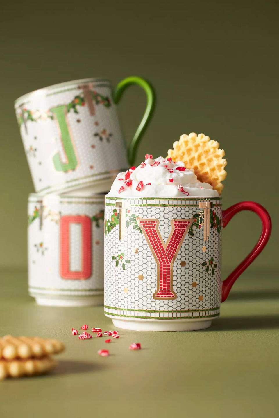 three monogram mugs one filled with whipped cream