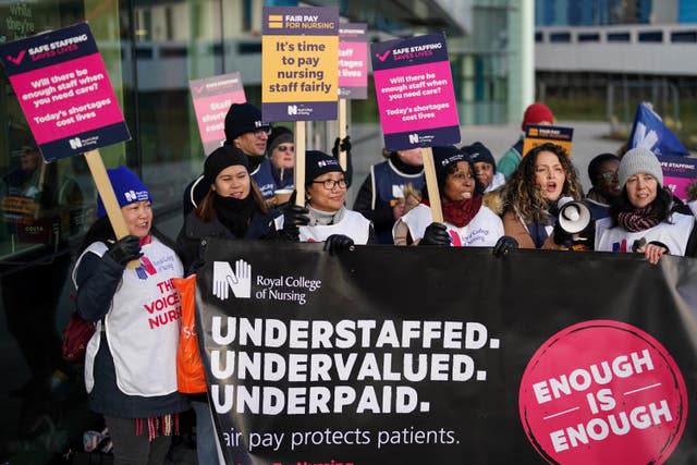 Workers on the picket line outside Queen Elizabeth hospital in Birmingham (Jacob King/PA)