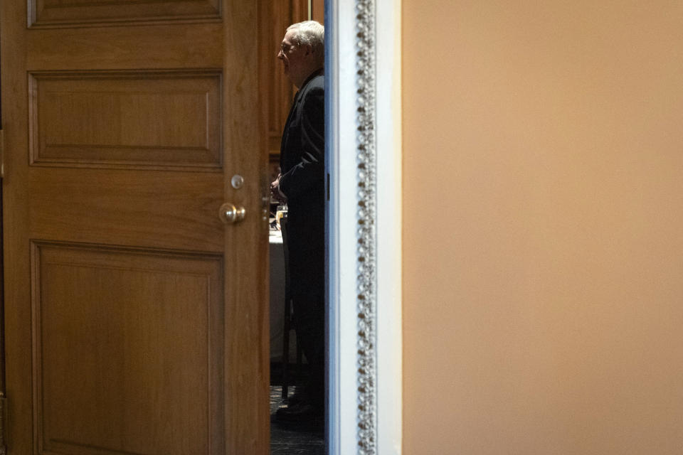 Senate Minority Leader Mitch McConnell of Ky., is seen through an open door while attending a Republican luncheon, Wednesday, Feb. 28, 2024 at the Capitol in Washington, after announcing that he will step down as Senate Republican leader in November. The 82-year-old Kentucky lawmaker is the longest-serving Senate leader in history. He's maintained his power in the face of dramatic changes in the Republican Party. (AP Photo/Jacquelyn Martin)
