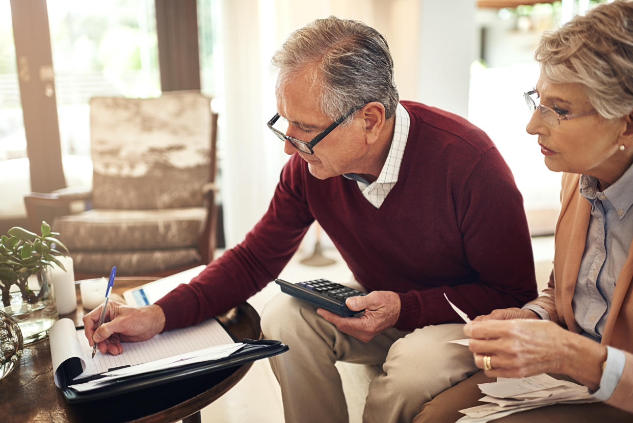 Shot of an elderly couple working out a budget while sitting on the living room sofa