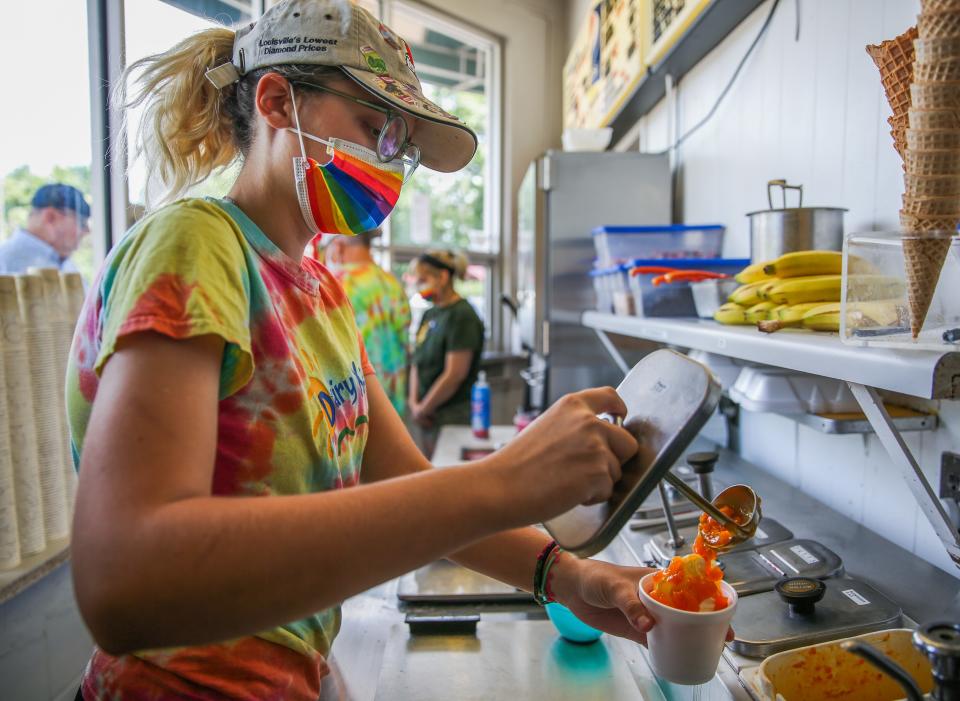 Gabby Jolley, 17, prepares ice cream for a customer while working at Dairy Kastle in Louisville, Kentucky on June 21, 2022.