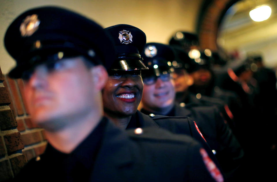 Chicago Fire department candidate firefighter Gwen Stevenson smiles as she waits for the start of her graduation ceremony in Chicago, Illinois, U.S. May 31, 2016.   REUTERS/Jim Young