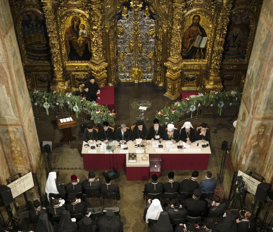 Ukrainian President Petro Poroshenko, backgrounder third left, attends a closed-door synod of three Ukrainian Orthodox churches to approve the charter for a unified church and to elect leadership in the St. Sophia Cathedral in Kiev, Ukraine, Saturday, Dec. 15, 2018. Poroshenko has told the crowd "the creation of our Church is another declaration of Ukraine's independence and you are the main participants of this historic event." (Mikhail Palinchak, Ukrainian Presidential Press Service/Pool Photo via AP)