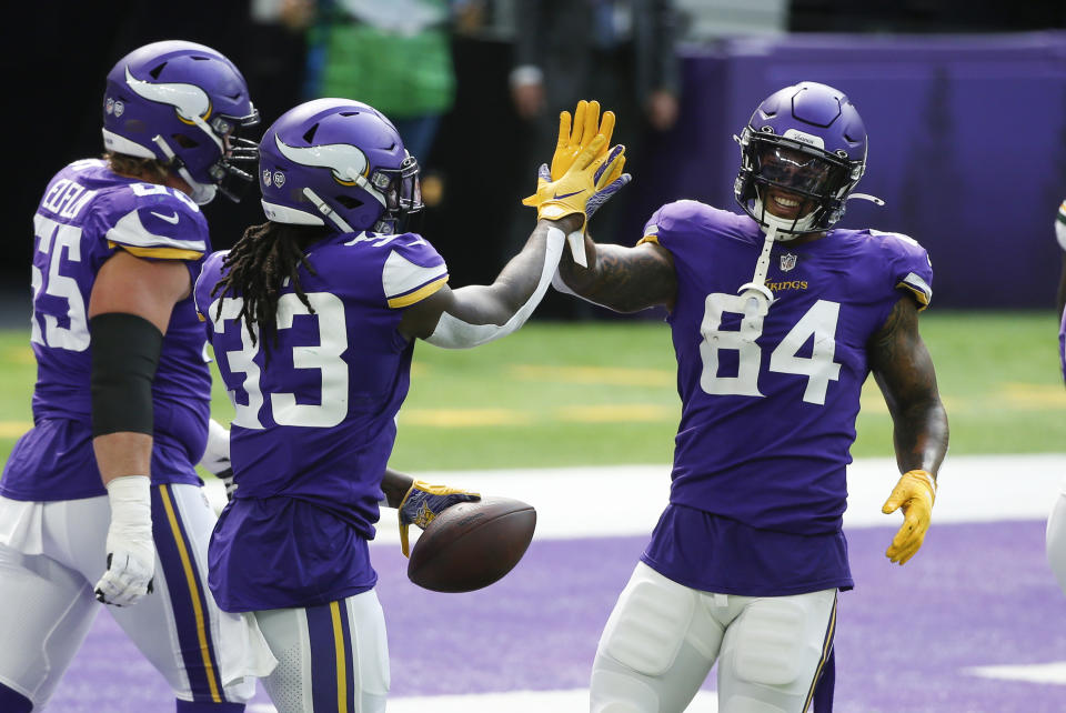 Minnesota Vikings running back Dalvin Cook celebrates with teammate Irv Smith (84) after scoring on a 1-yard touchdown run during the first half of an NFL football game against the Green Bay Packers, Sunday, Sept. 13, 2020, in Minneapolis. (AP Photo/Bruce Kluckhohn)