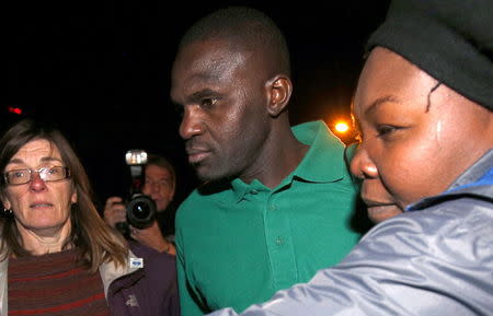 Sudanese migrant Abdul Haroun is greeted by his lawyer and support workers from a non-government refugee rights group as he leaves Elmley prison in southern England, Britain, January 4, 2016. REUTERS/Peter Nicholls