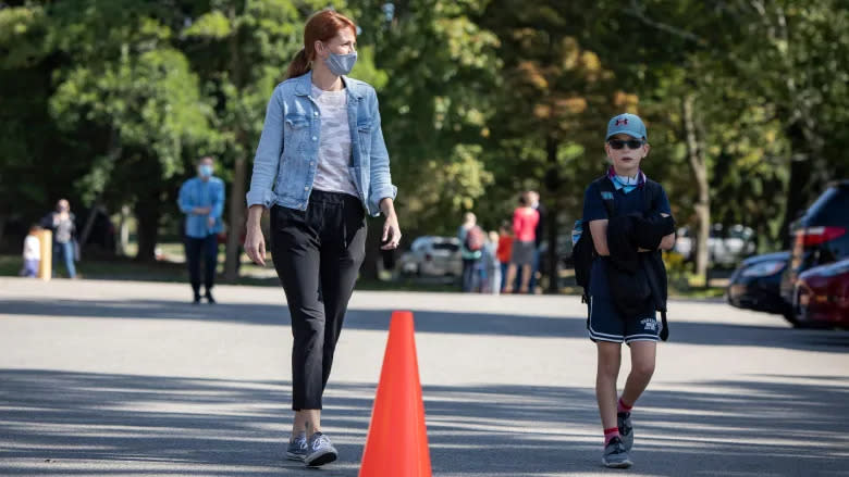 Tiffany Thornton picks up her son, Clark, 9, from his first day in fourth grade at White Oaks Public School in Mississauga on Friday. (Evan Mitsui/CBC)