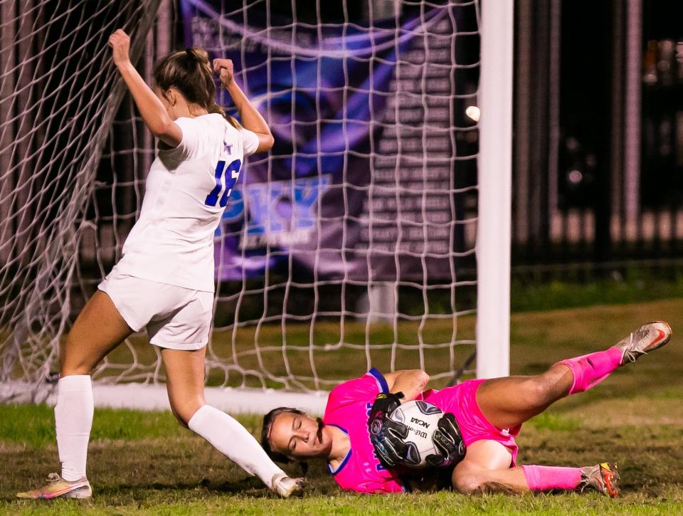 P. K. Yonge Blue Wave Norah Pancoast (00) makes a save as Bartram Trail Bears Avery McCormack (16) tries a goal attempt. P.K. Yonge hosted Bartram Trail in girls soccer at P.K Yonge High School in Gainesville, FL., Tuesday night, January 3, 2023. Bartram Trail lead 4-0 at the half.  [Doug Engle/Gainesville Sun]2023