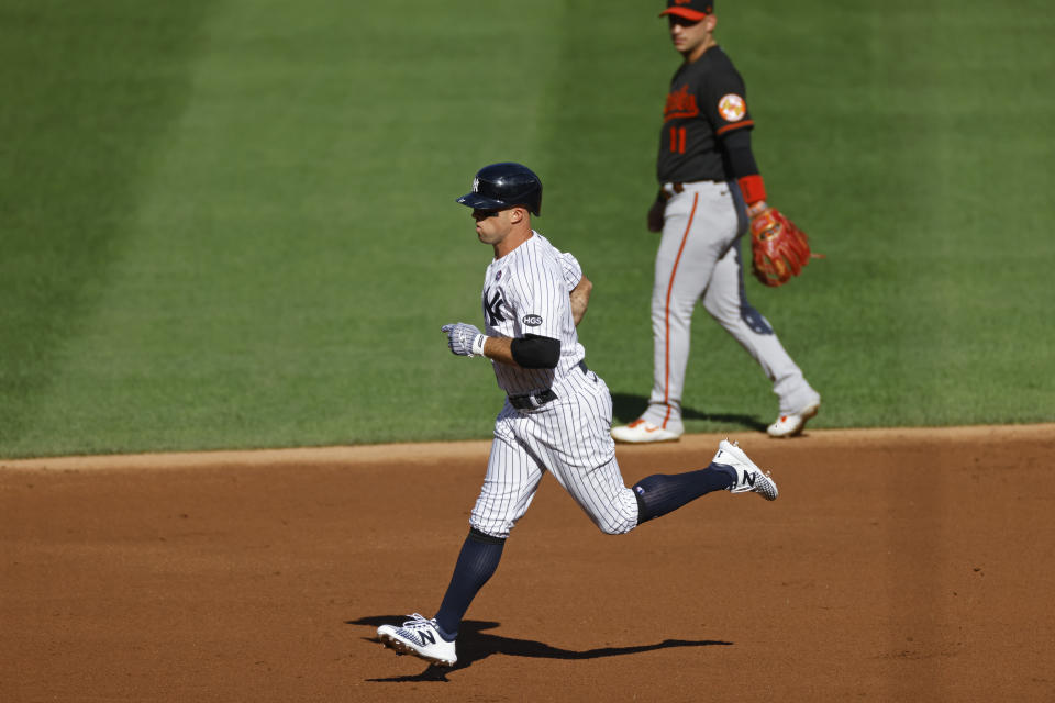 New York Yankees' Brett Gardner rounds the bases past Baltimore Orioles shortstop Jose Iglesias after hitting a two-run home run during the first inning of the first baseball game of a doubleheader, Friday, Sept. 11, 2020, in New York. (AP Photo/Adam Hunger)