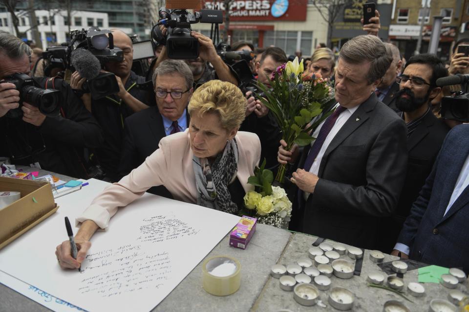 <p>Premier of Ontario Kathleen Wynne and Toronto Mayor John Tory visit a memorial, Tuesday, April 24, 2018 in Toronto., the day after a driver drove a van down sidewalks, striking and killing numerous pedestrians in his path. (Photo: Galit Rodan/The Canadian Press via AP) </p>