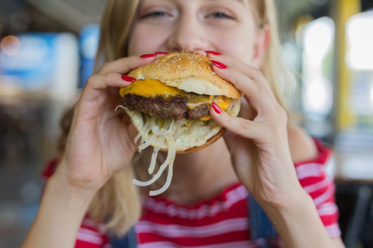 Woman eating beef burger