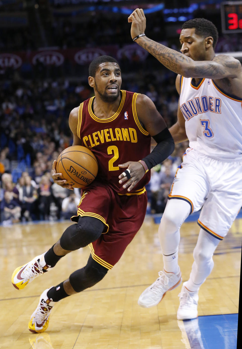 Cleveland Cavaliers guard Kyrie Irving (2) drives past Oklahoma City Thunder forward Perry Jones (3) during the first quarter of an NBA basketball game in Oklahoma City, Wednesday, Feb. 26, 2014. (AP Photo/Sue Ogrocki)