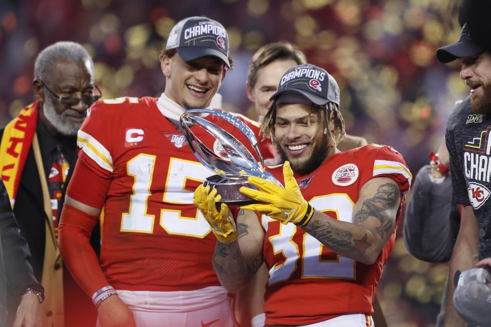 Kansas City Chiefs' Tyrann Mathieu and Patrick Mahomes (15) hold up the Lamar Hunt Trophy after the NFL AFC Championship football game against the Tennessee Titans Sunday, Jan. 19, 2020, in Kansas City, MO. The Chiefs won 35-24 to advance to Super Bowl 54. (AP Photo/Charlie Neibergall)