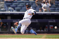 New York Yankees' Aaron Judge heads home while trying to beat the throw to the plate on Gary Sanchez's two-run double during the sixth inning of a baseball game against the Oakland Athletics, Sunday, June 20, 2021, at Yankee Stadium in New York. (AP Photo/Kathy Willens)