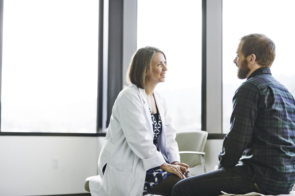 Female doctor talking to male patient 