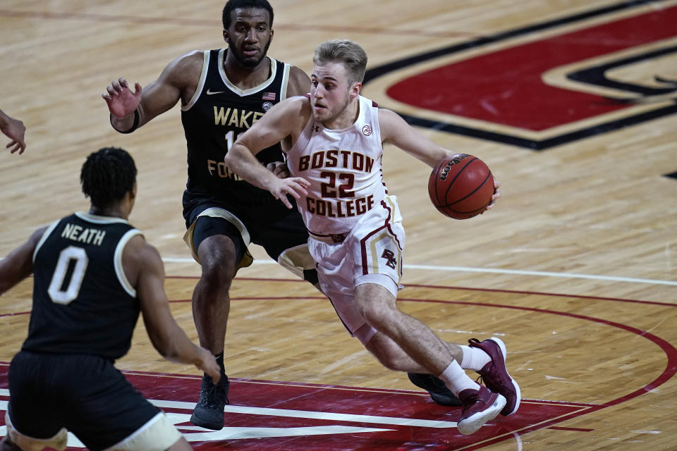 Boston College guard Rich Kelly (22) drives to the basket past Wake Forest guard Ian DuBose, rear, during the second half of an NCAA basketball game Wednesday, Feb. 10, 2021, in Boston. (AP Photo/Charles Krupa)