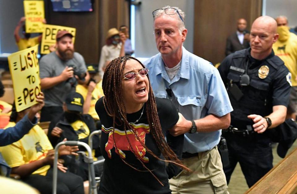 Maya Neal, a member of KC Tenants, was handcuffed and led out of the Kansas City Council chamber Thursday afternoon after protesters began shouting as city council members debated legislation on affordable housing. About 50 members of the city wide tenant union were on hand to protest the passing of housing legislation despite tenants showing strong opposition to the current definition of affordability.