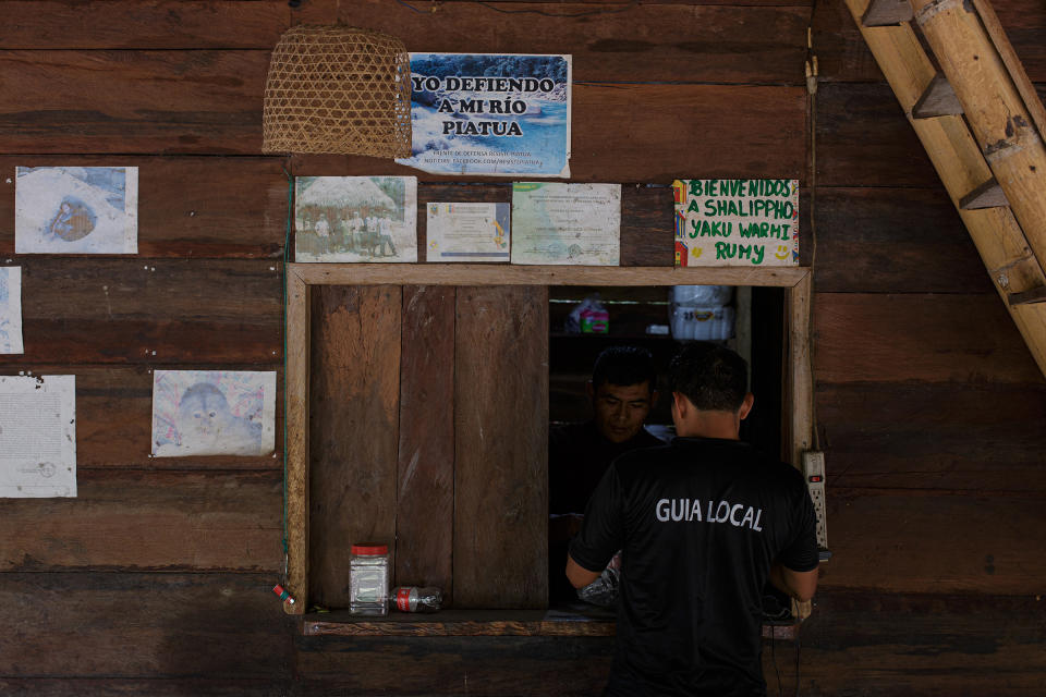 A sign in a local tourist center reading “I defend my Piatúa River.”<span class="copyright">Andrés Yépez for TIME</span>