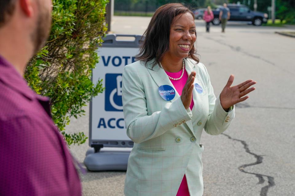 Lt. Gov. Sabina Matos greets voters at the Barrington High School polling place on Tuesday.