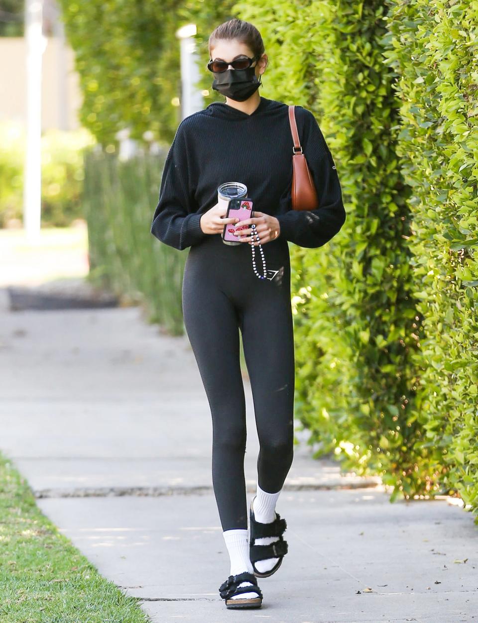 <p>Kaia Gerber steps out on Thursday in L.A. wearing all black and white tube socks.</p>