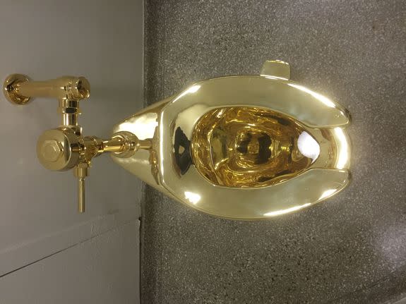 A fully functioning solid gold toilet, made by Italian artist Maurizio Cattelan, is going into public use at the Guggenheim Museum in New York on September 15, 2016.  A guard will be stationed outside the bathroom to protect the work, entitled 'America', which recalls Marcel Duchamp's famous work, 'Fountain'. / AFP / William EDWARDS        (Photo credit should read WILLIAM EDWARDS/AFP/Getty Images)