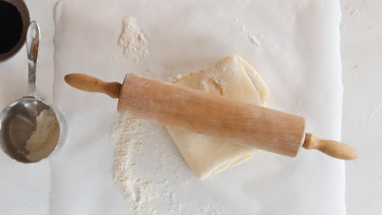 dough folded and rolled out with rolling pin