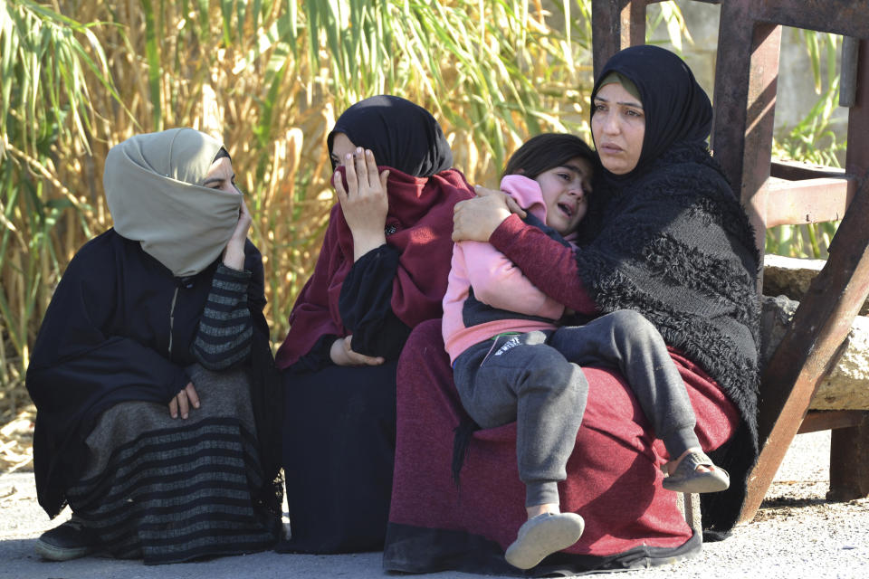 File - Syrian women relatives of migrants who were rescued Saturday by the Lebanese navy wait their relatives to be released outside a navy base, in Tripoli, north Lebanon, Sunday, Jan. 1, 2023. Lebanon's navy and U.N. peacekeepers have rescued more than 200 migrants from a boat sinking in the Mediterranean Sea hours after it left northern Lebanon's coast, the military said in a statement. (AP Photo, File)