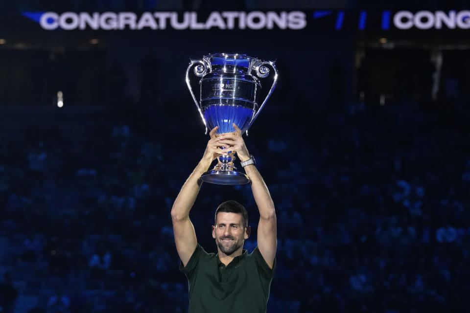 Serbia's Novak Djokovic holds the trophy as ATP world best player at the ATP World Tour Finals, at the Pala Alpitour, in Turin, Italy, Monday, Nov. 13, 2023. Djokovic was presented with the trophy for finishing the year ranked No. 1. (AP Photo/Antonio Calanni)