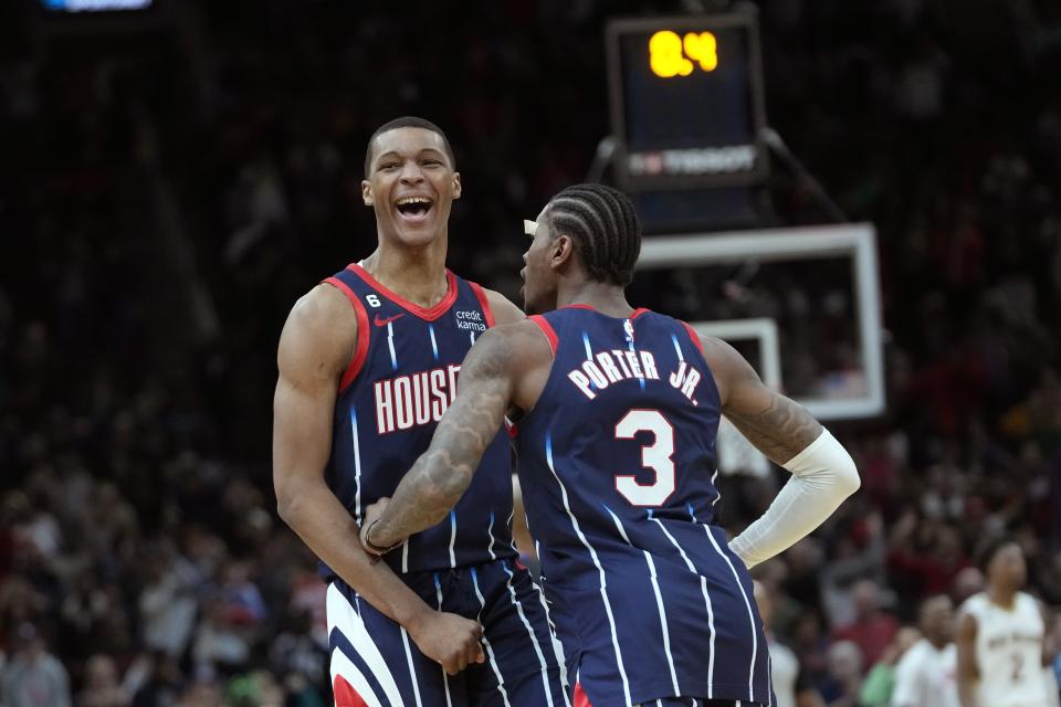 Houston Rockets' Jabari Smith Jr., left, celebrates with Kevin Porter Jr. (3) after making a game-winning basket against the New Orleans Pelicans during the second half of an NBA basketball game Friday, March 17, 2023, in Houston. The Rockets won 114-112. (AP Photo/David J. Phillip)