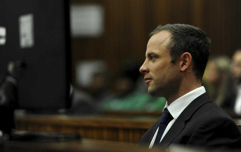 Oscar Pistorius sits in the dock as he listens to cross questioning about the events surrounding the shooting death of his girlfriend Reeva Steenkamp, in court during the second week of his trial in Pretoria, South Africa, Wedensday, March 12, 2014. Pistorius is charged with the shooting death of Steenkamp, on Valentines Day in 2013. (AP Photo/Werner Beukes, Pool)