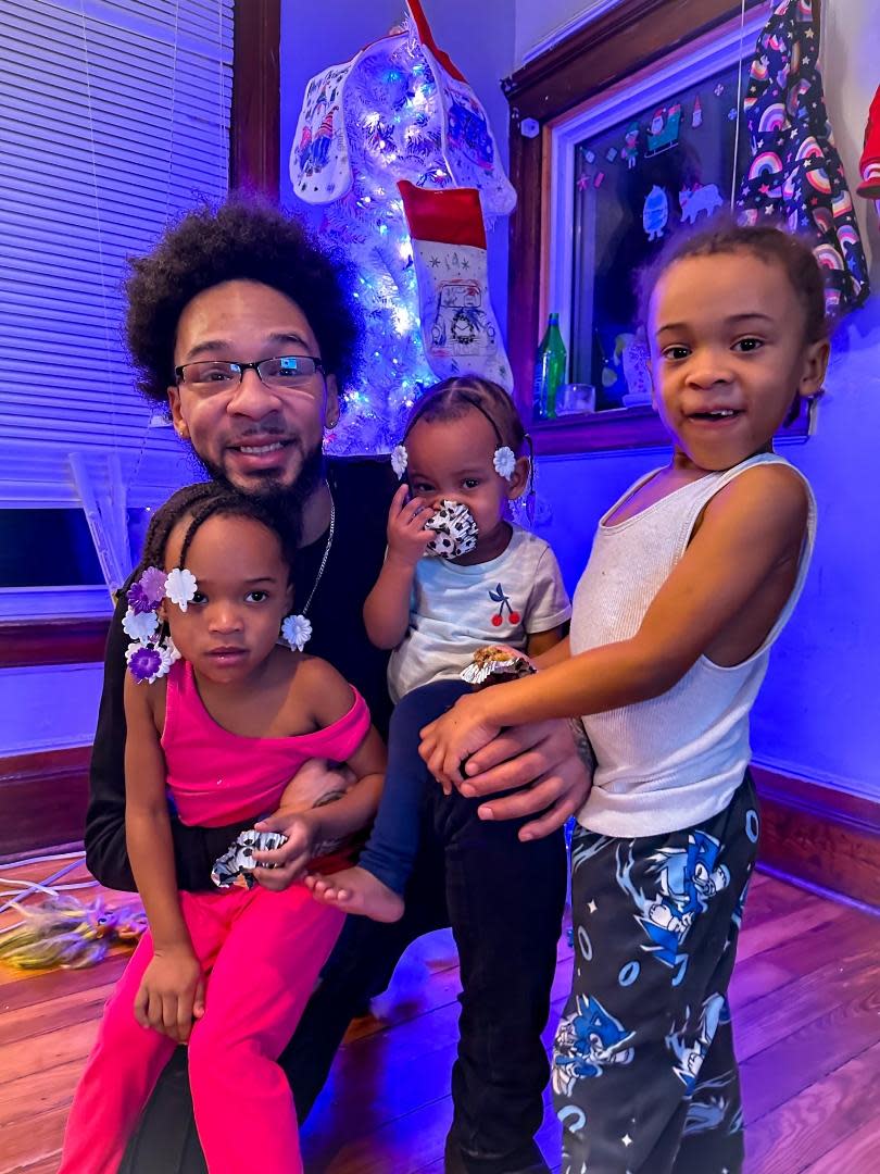 Donald Wilson Sr. with his children (left to right) Poetry, Honesty and Donald Jr.