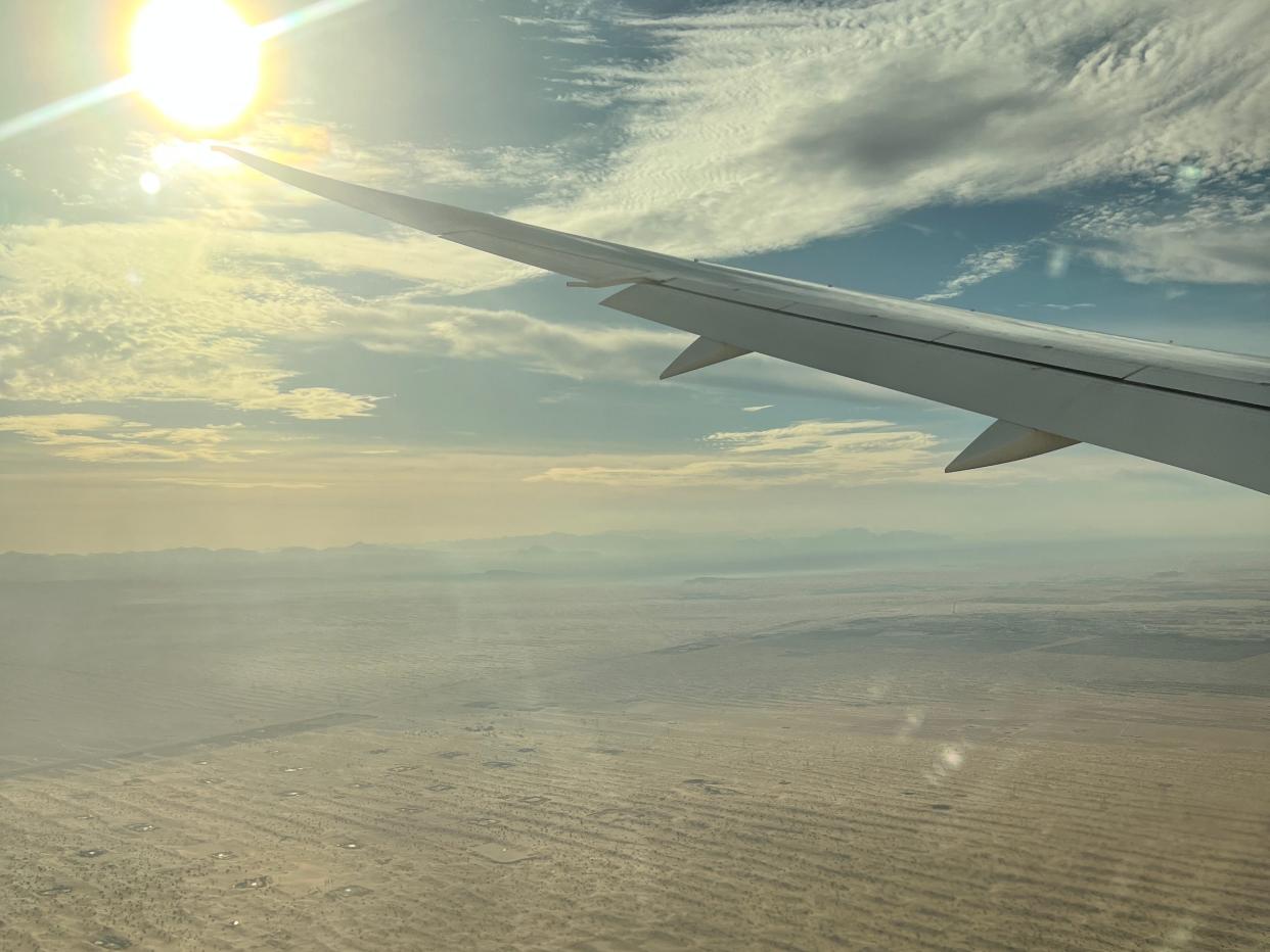 A view out the window of a BA Boeing 787 above the desert near Dubai on approach to landing at DXB