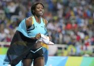 2016 Rio Olympics - Athletics - Final - Women's 400m Final - Olympic Stadium - Rio de Janeiro, Brazil - 15/08/2016. Shaunae Miller (BAH) of Bahamas holds her shoes in her hands as she celebrates after winning the gold medal. REUTERS/Sergio Moraes